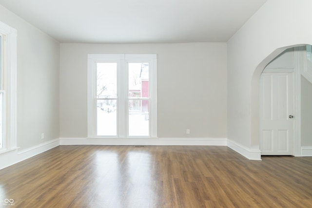 spare room with dark wood-type flooring