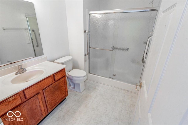 bathroom with vanity, toilet, and walk in shower