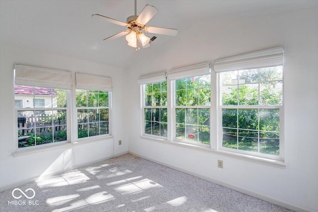 unfurnished sunroom featuring ceiling fan and vaulted ceiling