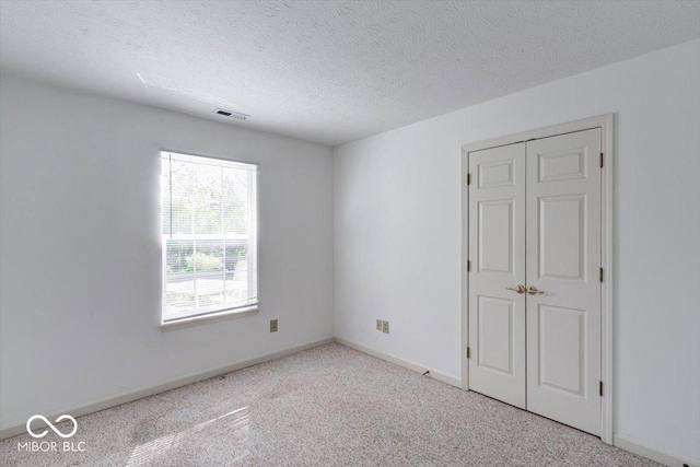 spare room with a textured ceiling