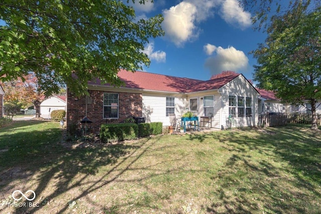 rear view of house featuring a lawn