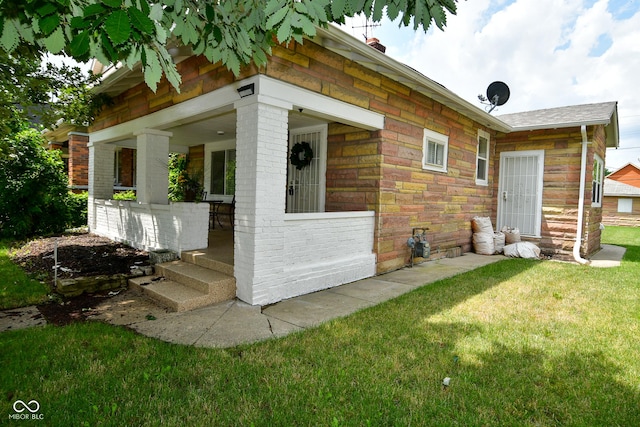 view of side of home with a yard