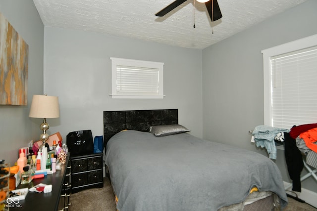 bedroom with carpet, a textured ceiling, and ceiling fan