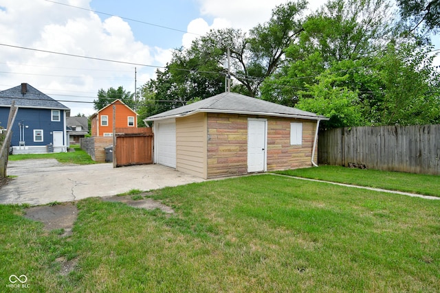 view of outbuilding featuring a lawn and a garage