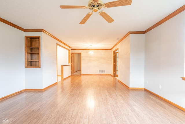 unfurnished room featuring hardwood / wood-style flooring, built in features, ceiling fan, and ornamental molding