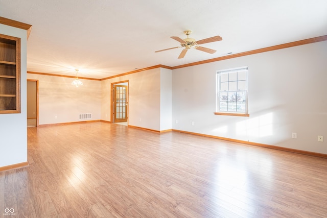 unfurnished room featuring light wood-type flooring, french doors, ceiling fan with notable chandelier, and crown molding