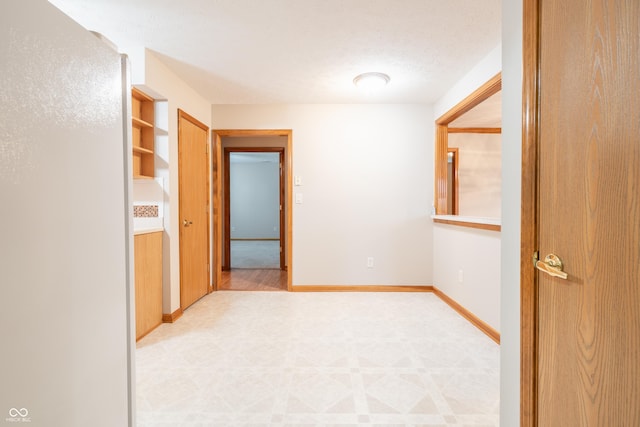 hallway with a textured ceiling