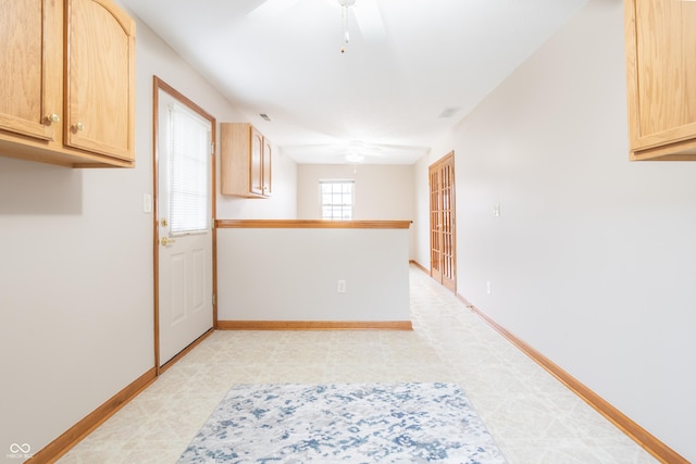 kitchen with light brown cabinetry and ceiling fan