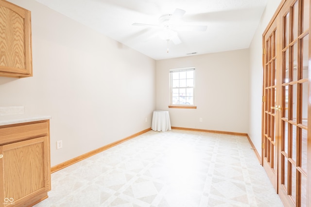 unfurnished room featuring ceiling fan and french doors