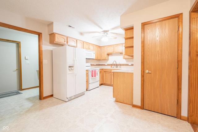 kitchen with light brown cabinets, white appliances, sink, ceiling fan, and a textured ceiling