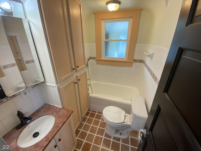 bathroom with tile patterned flooring, vanity, toilet, and tile walls