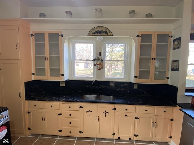 kitchen featuring white cabinetry, sink, dark stone counters, decorative backsplash, and dark tile patterned flooring