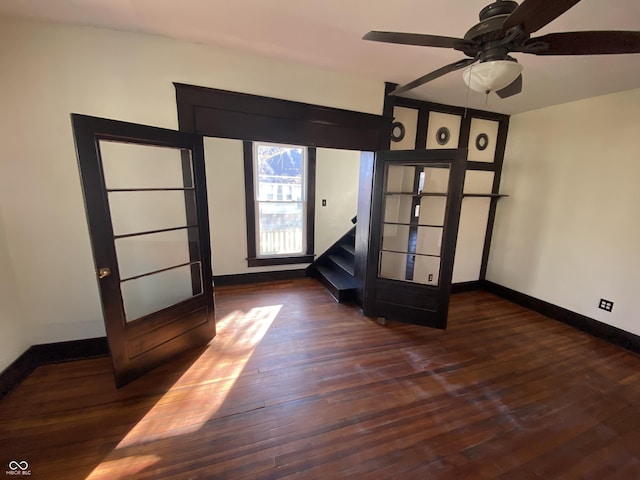 spare room featuring french doors, dark hardwood / wood-style flooring, and ceiling fan