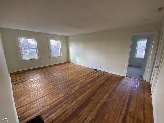 empty room with dark hardwood / wood-style floors