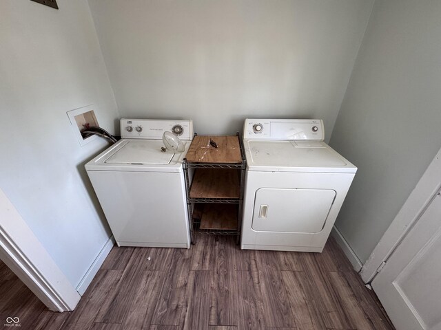 laundry area with washer and dryer and dark wood-type flooring