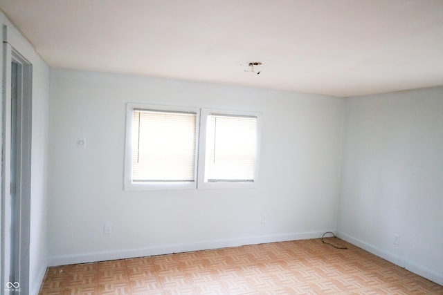 unfurnished room featuring light parquet flooring