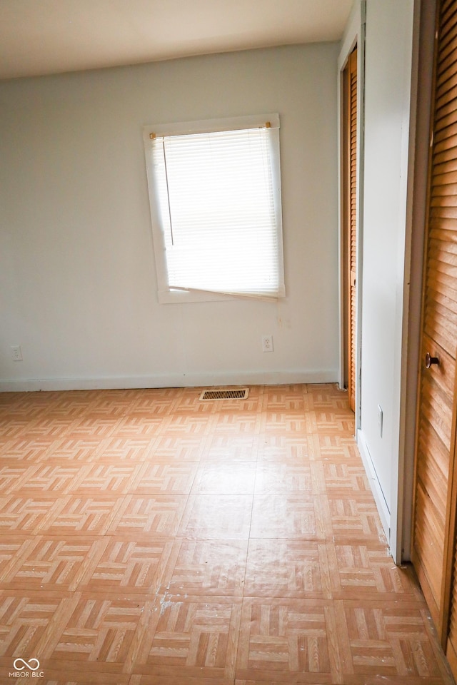 unfurnished bedroom featuring light parquet flooring