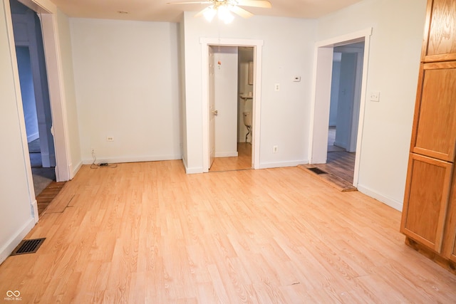 empty room with light hardwood / wood-style floors and ceiling fan