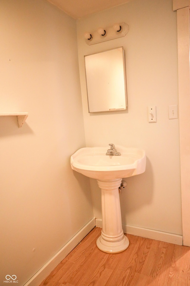 bathroom with hardwood / wood-style flooring