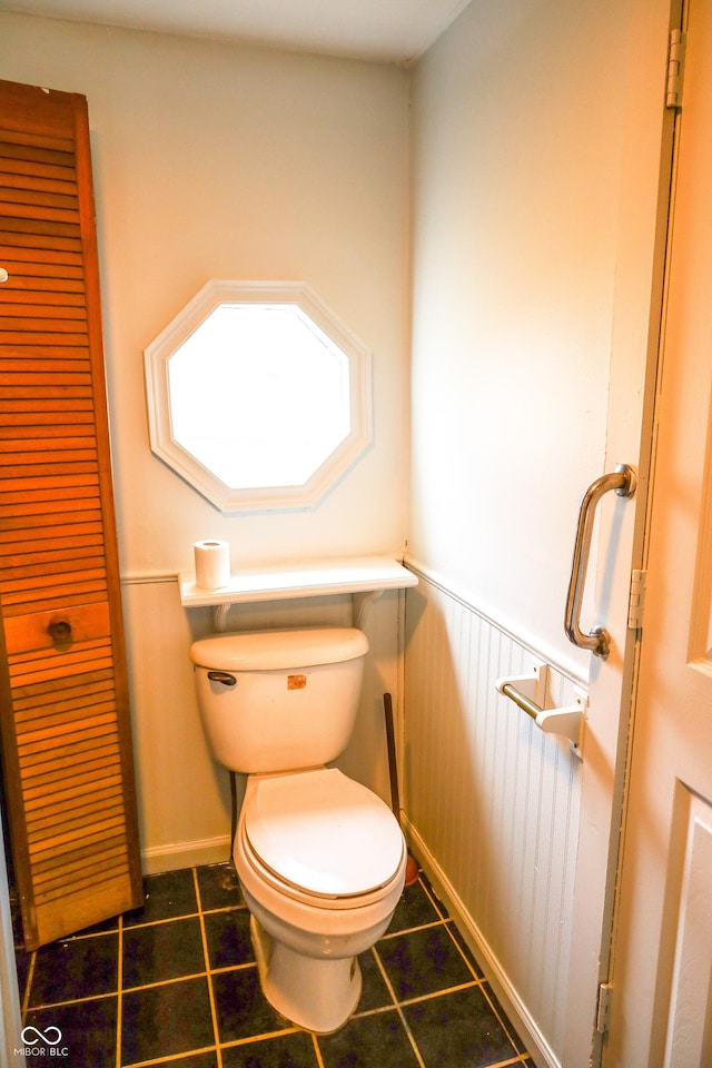 bathroom with toilet and tile patterned flooring