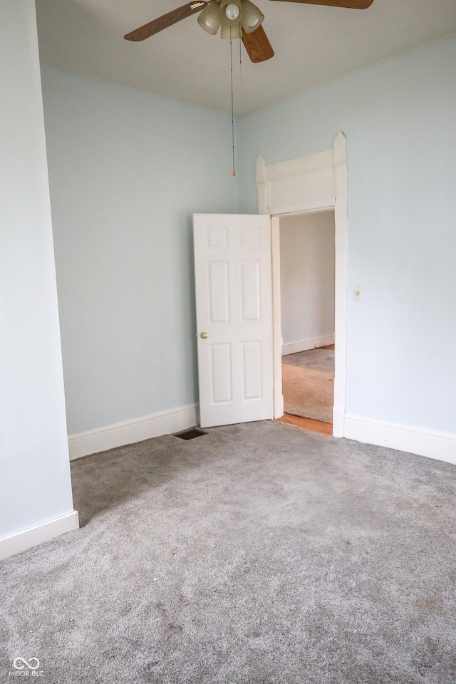 spare room featuring carpet and ceiling fan