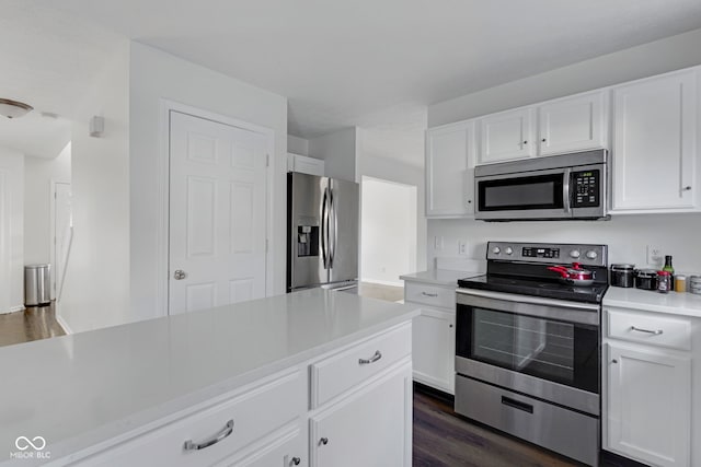 kitchen featuring dark hardwood / wood-style floors, white cabinetry, and appliances with stainless steel finishes