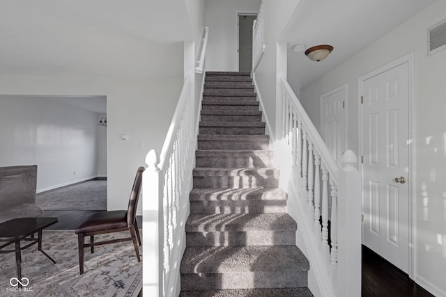 staircase featuring hardwood / wood-style flooring