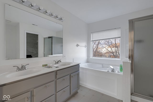 bathroom with vanity and separate shower and tub