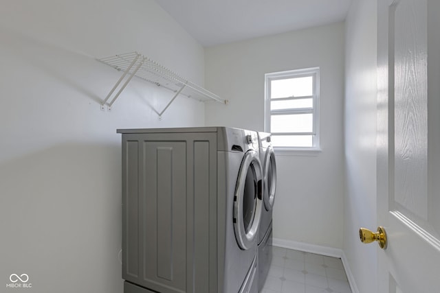 washroom with washing machine and clothes dryer