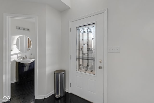 entryway with dark hardwood / wood-style floors and sink