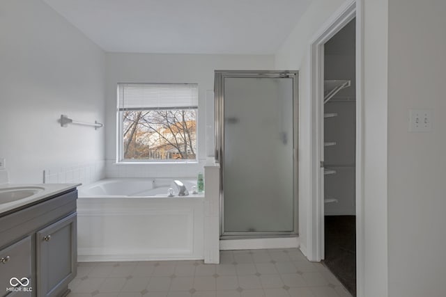 bathroom featuring vanity and independent shower and bath