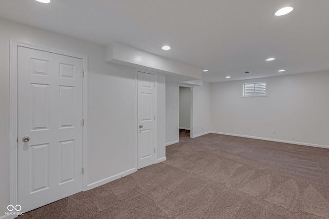 basement featuring light colored carpet