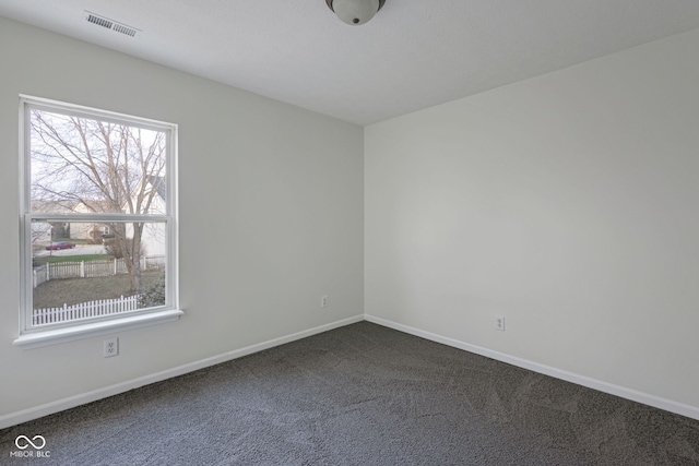 unfurnished room with dark carpet