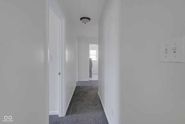 hall featuring dark colored carpet