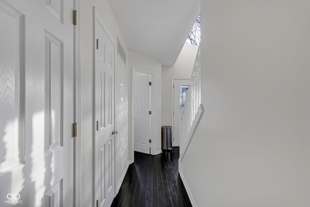 corridor featuring dark wood-type flooring