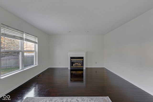 unfurnished living room featuring dark hardwood / wood-style flooring