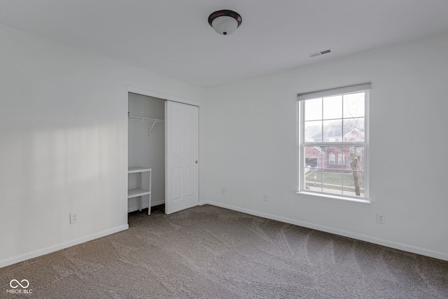 unfurnished bedroom featuring a closet and carpet floors