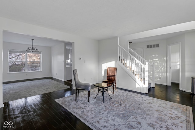 interior space with dark hardwood / wood-style flooring and an inviting chandelier