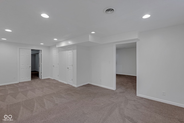 unfurnished room featuring light carpet