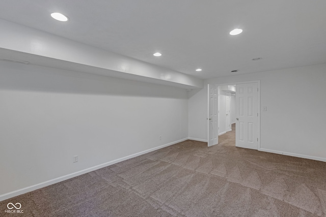 basement featuring light colored carpet