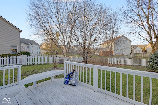 wooden deck featuring a lawn