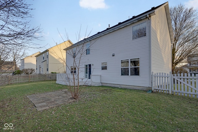 rear view of house with a lawn