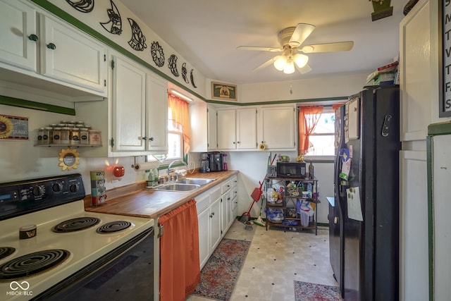 kitchen with electric range, ceiling fan, white cabinets, and sink