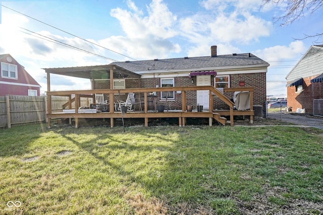 back of house with a lawn and a deck