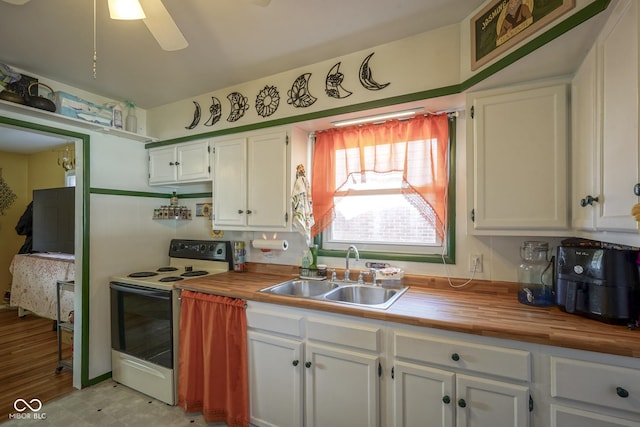 kitchen with wood counters, white electric range, sink, ceiling fan, and white cabinetry