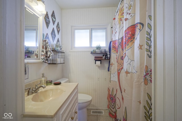 bathroom featuring tile patterned flooring, vanity, and toilet