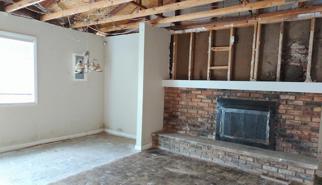 unfurnished living room featuring a brick fireplace and plenty of natural light