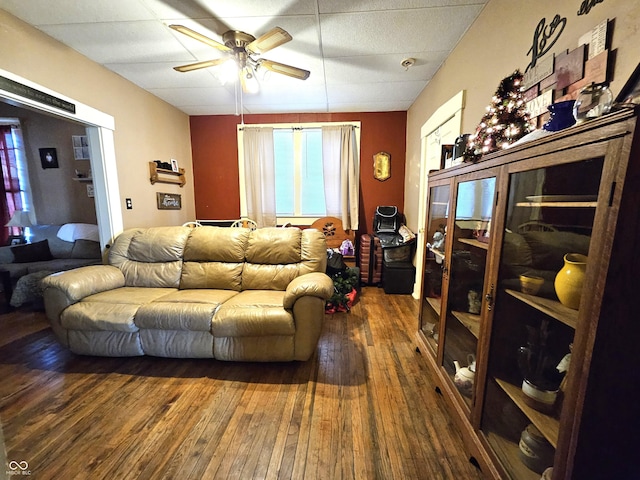 living room with dark hardwood / wood-style flooring and ceiling fan