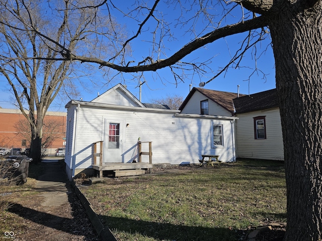 back of house with a lawn