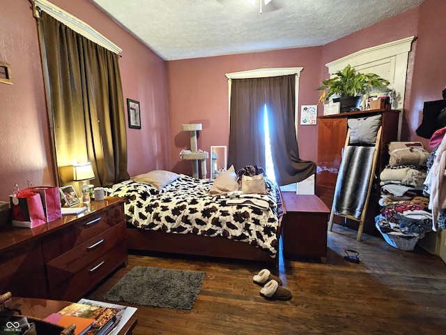 bedroom featuring dark hardwood / wood-style floors and a textured ceiling